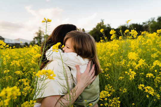 Loving Child Embraces Her Mom