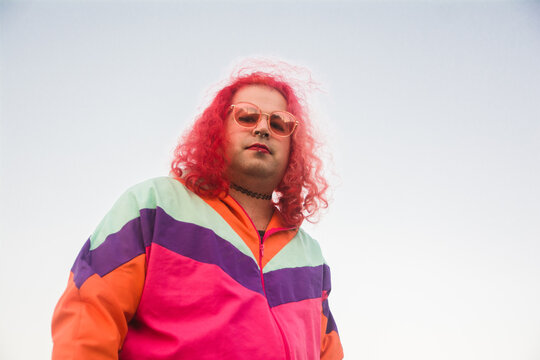 Transgender woman in colorful jacket looking at camera