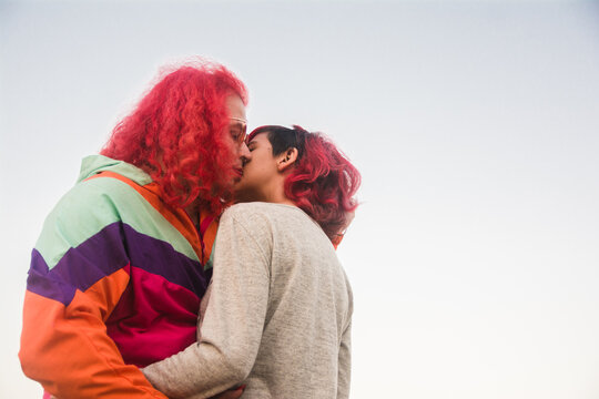 Trans woman and non-binary person kissing