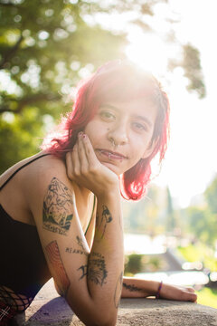 Nonbinary person with tattoos portrait