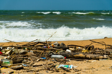 Plastic and wood waste on the beach pollute the environment. Negombo, Sri Lanka.