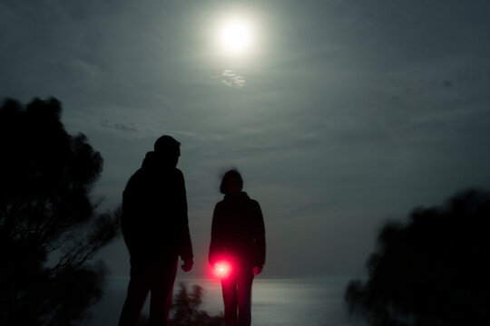 Couple exploring the night with red light