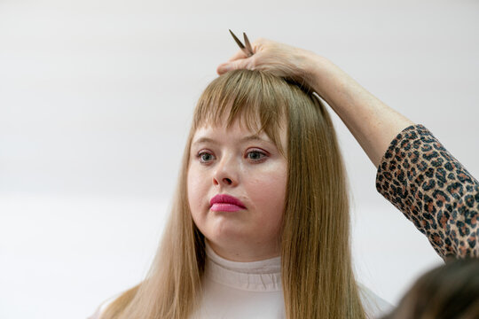 glamour woman with down syndrome  getting a haircut 