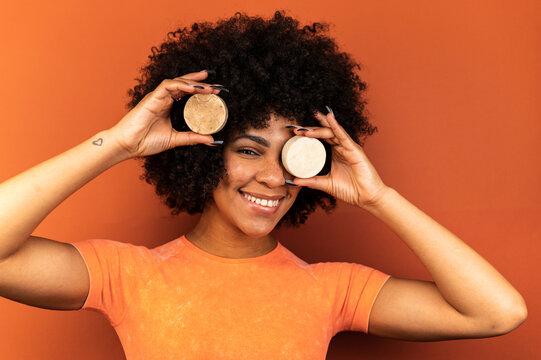 Brown skinned woman displaying handmade soap