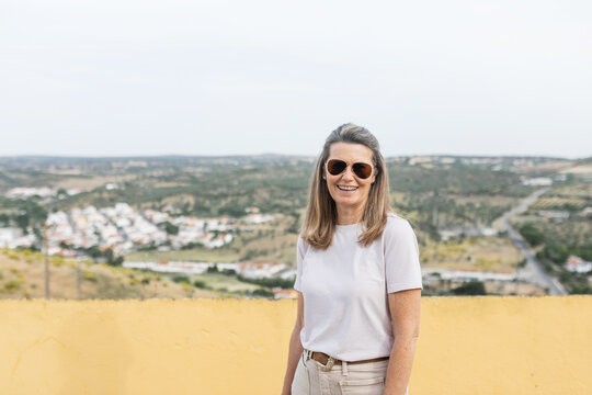 mature tourist woman on top of a village with a rural landscape