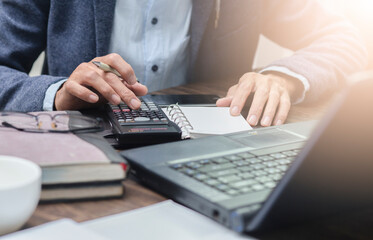 businessman using calculator  at workplace, financial and accounting concept