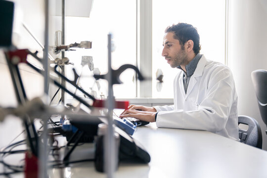 Male Scientist Using Laptop In Lab