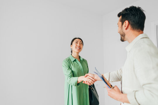 Real Estate Agent Shaking Hands with Client