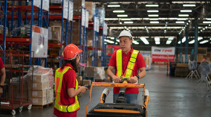 Male and female warehouse workers work at a distribution center. talking Analyze new arrivals of additional items in the warehouse department. Employees who organize the distribution of goods to the m