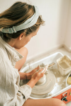 Woman in pottery home studio. 