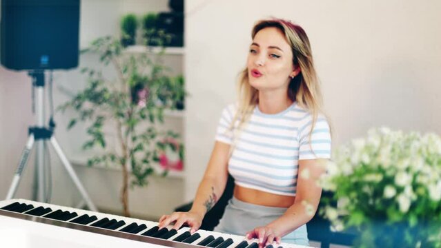 4k beautiful woman singing and playing piano. Emotional female vocalist and musician. Training tutorial in white studio. Rehersal performance voice training.
