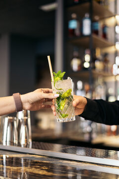 Waiter serving a mojito