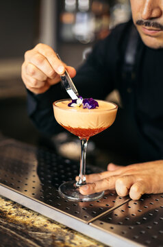 Bartender decorating a cocktail