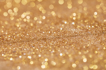 Gold yellow sparkling sand from vintage hourglass