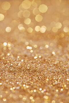 Texture pattern of golden glowing sand