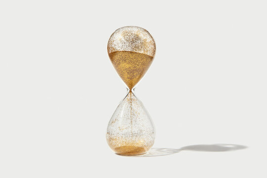 Hourglass with flowing golden sand inside