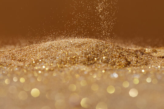 Close up of sand grains falling on pile