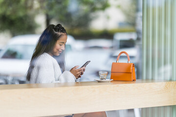 chatting with phone in cafe