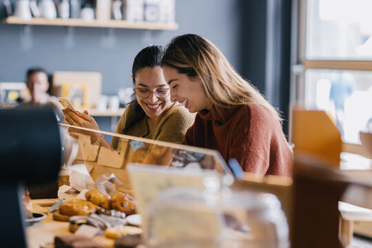 Friends Meeting In Coffee Shop And Talk  - Powered by Adobe