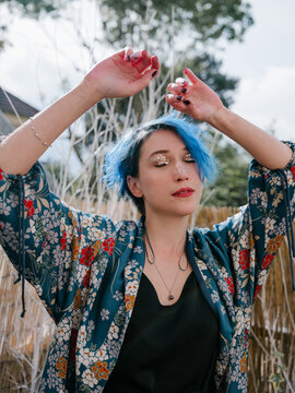 Portrait of a young women with blue short hair meditating