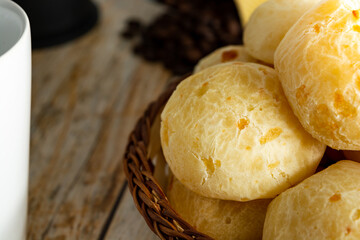 close up cheese bread, or brazilian pão de queijo. coffee beans on the background over wooden table