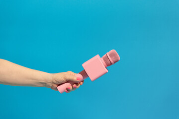 Pink microphone on blue background