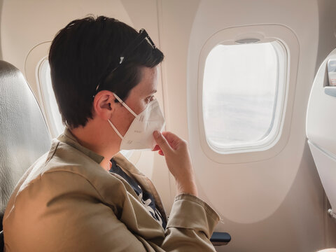 Woman With Medical Mask Flying On A Plane