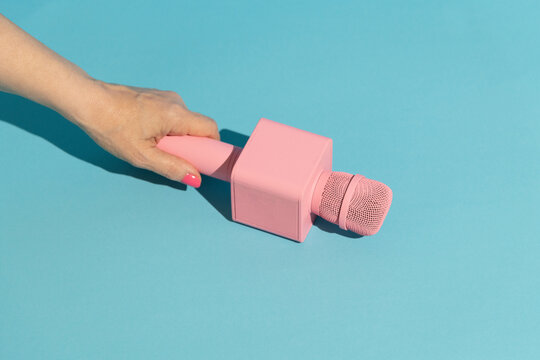 Pink microphone on blue background