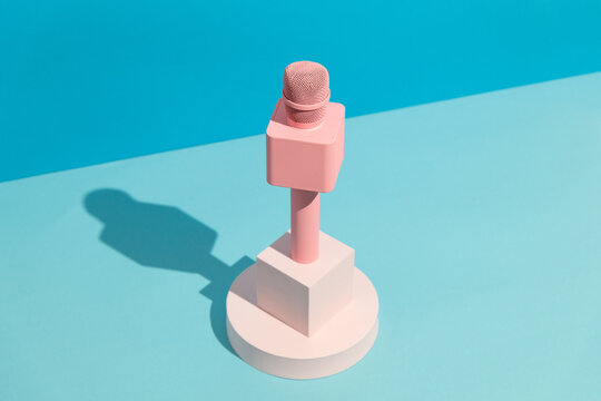 Pink microphone on blue background