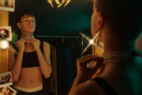 Young Man Trying On Bead Necklace