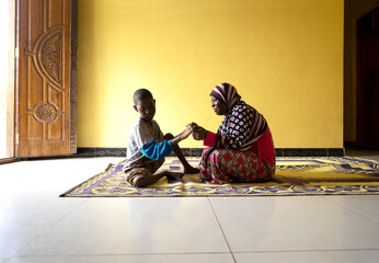 A Mother holds hands with her mentally and physically disabled son. 