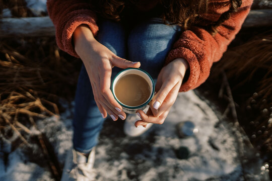 woman with ice skates pouring a hot drink