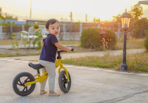 Asian Toddler Boy enjoy riding Balance Bicycle , Having Fun