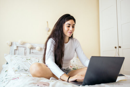 Young happy woman using laptop