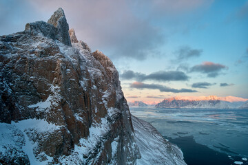 Uummannaq island, Greenland Arctic, mountain peak and winter sea ice