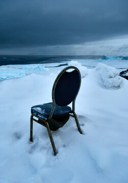 Arctic winter outlook - old seat, chair buried in snow, bleak outlook