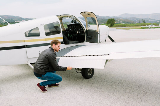 Pilot cheking the flats of the plane
