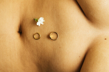Jewelry and jasmine flower on belly button