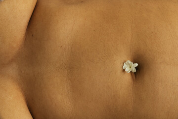 Single jasmine flower on belly button