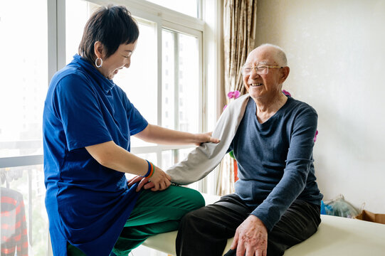 Physical therapist helping senior man patient