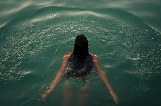 Unrecognisable woman swimming in the lake