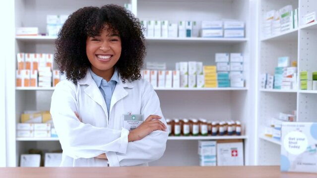 Portrait of a happy pharmacist working on digital tablet behind a pharmacy counter. Woman using technology to access drug database, for inventory checkup or dispensing online medicine prescriptions