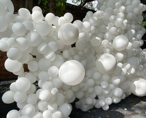 Sticker written on white balloon wall at party