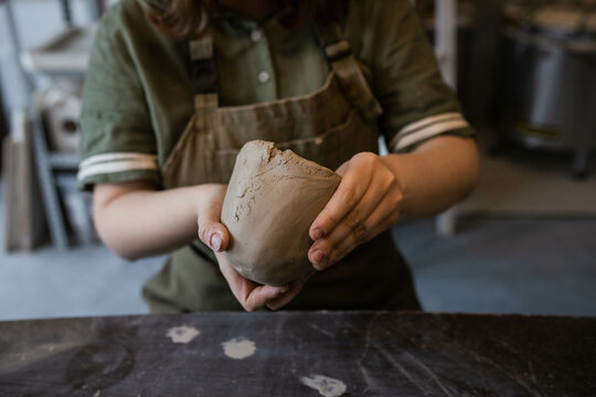 The creative process of creating a clay mug by a female ceramist - Powered by Adobe