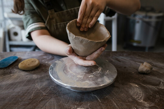 The hands of the Creator in clay