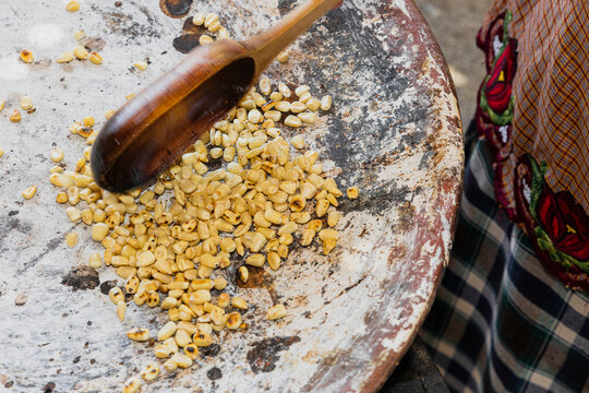 Kernels of yellow corn on a comal (griddle) 