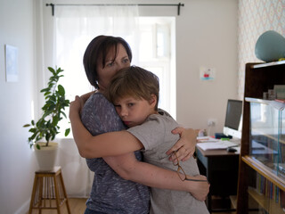 mother hugging teen son