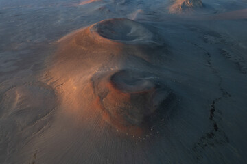 Volcanic craters with steam in highland