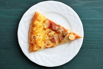 Slice of Pizza with meat topping, close up
