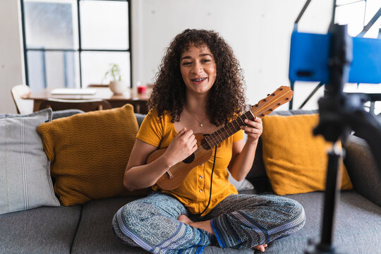 Hispanic Vlogger Recording Herself Playing The Ukelele 